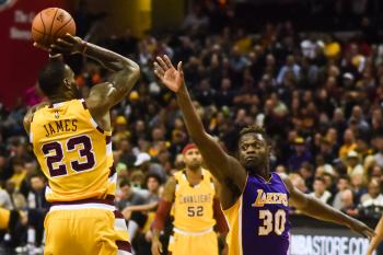 LeBron James takes a jump shot over Erik Drost's head.